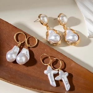 Elegant Baroque pearl drop earrings set with gold-plated accents in three unique designs