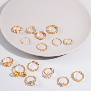 Set de 15 anillos de aleación dorada con mariposa, perla y estrás en diseños geométricos