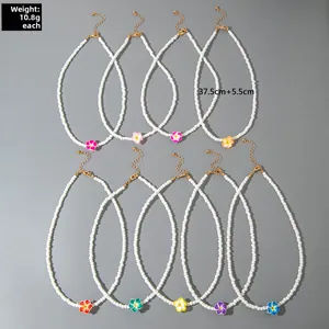 Set of nine beaded necklaces featuring colorful resin flowers and golden lobster clasps