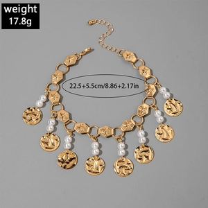 Detail showing golden bohemian anklet with faux pearls, coin charms and size markings