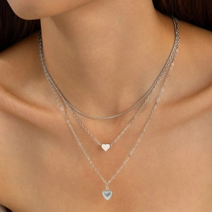 Three-layer silver alloy necklace with heart pendant and snake chain on model