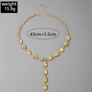 Detail of gold-tone irregular pebble pendant with Y-shaped chain design and dimensions