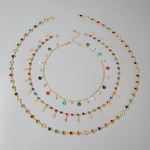 Gold layered necklace set with colorful crystals, heart charms and star pendants