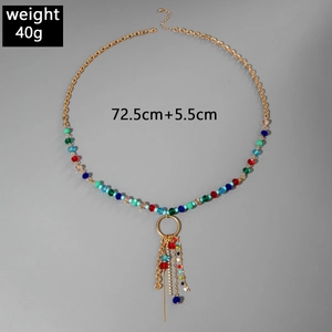 Detail of colorful beads and gold tassels on a bohemian multi-layer Y-shaped necklace
