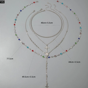 Detailed layered silver chain necklace featuring colorful crystals and religious pendants