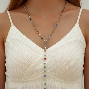 Detail of silver Y-necklace with multi-color crystals, pearls, and LOVE engraved charms