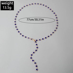 Detail of multi-layered gold necklace with blue crystals and 77cm length measurement