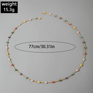 Detailed view of colorful evil eye beads on a golden layered Y-necklace with size info