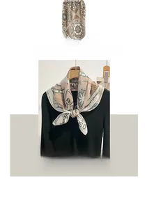 Detail of elegant cotton linen scarf showing retro chain patterns and buckle motifs