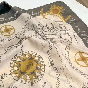 Light beige fashion silk scarf with nautical prints of sailboats, compasses and ropes