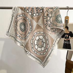 Elegant silk square scarf with vintage chain patterns in beige and brown hanging display