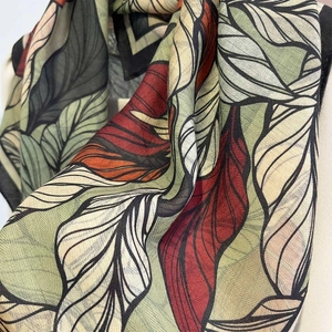 Detailed close-up of tropical leaf print silk scarf with fine diagonal twill texture