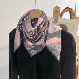 Pink and grey floral silk feel neck scarf displayed on a black sweater for women