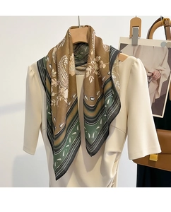 Detail of silk square scarf with vintage paisley pattern draped on a hanger