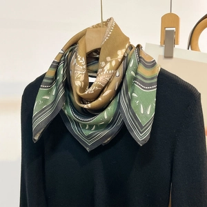 Elegant retro printed square silk scarf with floral patterns on a black turtleneck