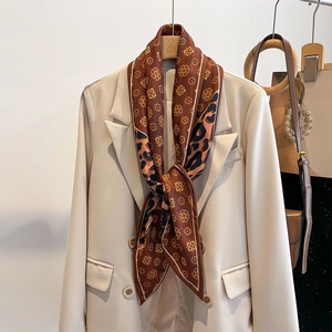Élégant foulard en soie imprimé léopard et fleurs sur un blazer chic crème