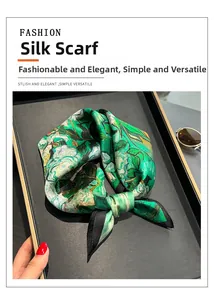 Detailed view of Monet oil painting silk scarf displayed on a luxury matte tray