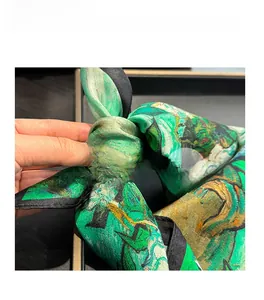 Macro detail of high-quality silk scarf showing soft texture and Monet oil painting print