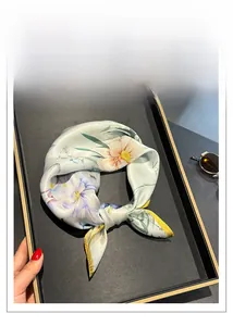 Detail of floral print silk scarf in gift box with lavender and orange blossoms