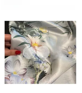 Macro view of 100% mulberry silk fabric showing premium floral print and smooth texture