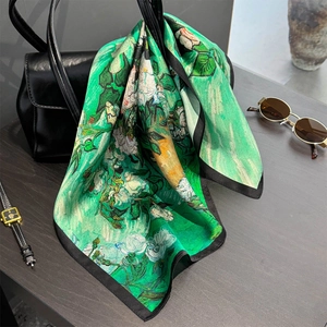 Silk scarf with Monet oil painting style flower print on elegant black leather handbag