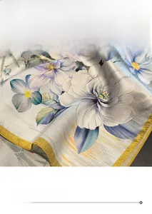 Detail showing the fine golden stitching and silk texture of floral print scarf