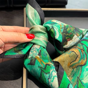 Detailed close-up of 100% silk scarf with Monet green oil painting pattern and black borders