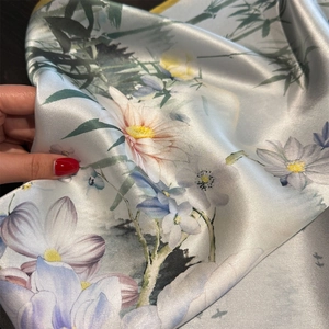 Detailed view of 100% mulberry silk scarf featuring elegant floral and bamboo leaf patterns
