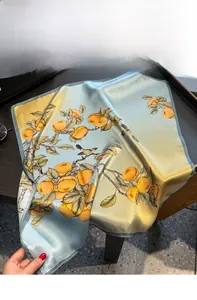 Detail of silk square scarf featuring vintage floral bird print and smooth texture