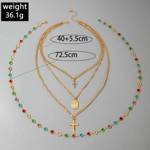 Detail of multilayer gold necklace with colorful crystals, cross and Mary pendant, 36.1g