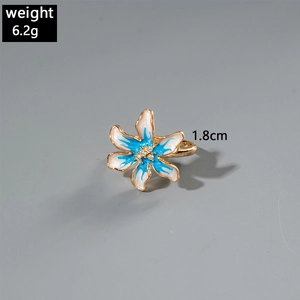 Dettaglio dell'anello barocco a camelia con petali bianchi e texture floreale blu