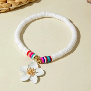 Detail of bohemian white clay heishi bead anklet with gold center flower charm