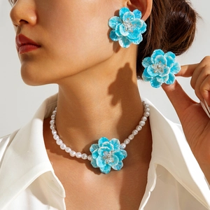 Blue floral jewelry set with resin flower petals and irregular pearl necklace on model