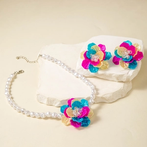 Detail of colorful resin floral jewelry set with white pearl necklace and matching earrings
