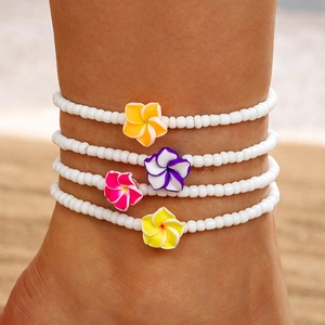 Set of four Bohemian white seed bead anklets with vibrant tropical plumeria flowers