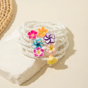 Bohemian beaded anklet set with colorful plumeria flower charms for summer beach vacations