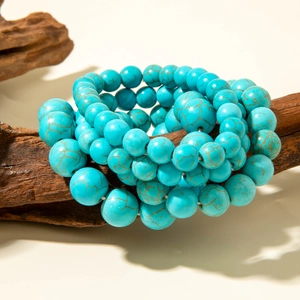 Bohemian turquoise bead stretch bracelet displayed on a rustic wood texture base