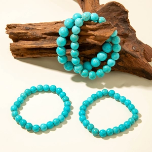 Bohemian turquoise bead bracelet set with natural patterns on warm background