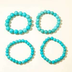 Detail view of four turquoise bead bracelets showing various bead sizes and natural textures