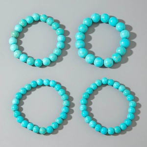 Set of four bohemian turquoise beaded bracelets with vintage matrix patterns in blue