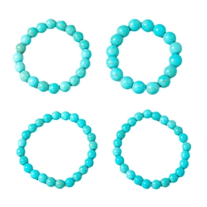 Set of four bohemian turquoise beaded bracelets with vintage brown veining on white background