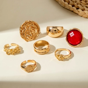 Golden liquid metal ring set with red gemstone and rose floral textures in 7-piece set