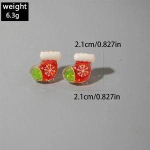 Detail showing red and green Christmas stocking earrings with glitter snowflake patterns
