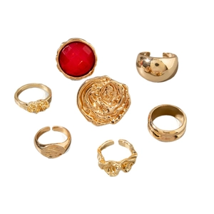 7-piece gold liquid metal ring set with red gemstone and hammered textures