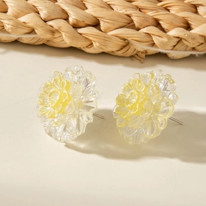 Chic yellow floral earrings with layered crystal petals on a natural woven background