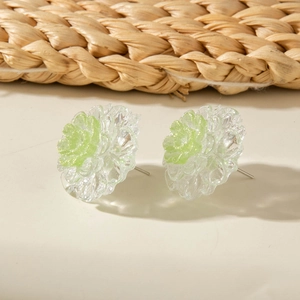 Detail shot of pastel 3D flower stud earrings with resin petals and green glitter center