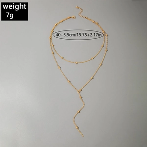 Detail of gold-layered Y-necklace featuring starfish and cross charms with dimensions