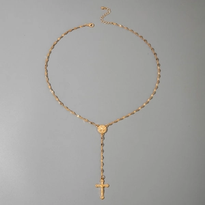 Detailed close-up of gold Y-shaped necklace with religious icon medal and crucifix pendant
