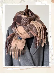 Close-up of thick winter scarf with vintage plaid pattern and long tassel fringes