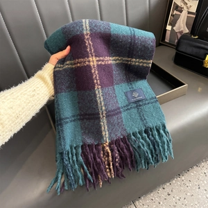 Detail of vintage plaid scarf featuring dark teal and purple tartan with soft tassels